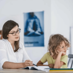 Therapist supporting a child during an online learning or counseling session